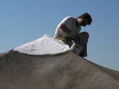 a man riding a skateboard down the side of a cement ramp