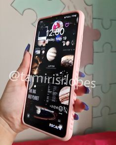 a woman holding up a pink phone with pictures on the front and back cover in her hands