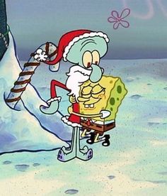 spongebob with santa hat and candy cane in the snow