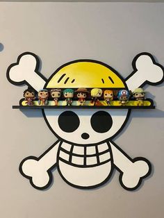 there is a shelf that has some toys on it with skulls and bones above it