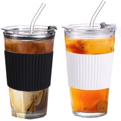 two cups with lids and straws filled with liquid