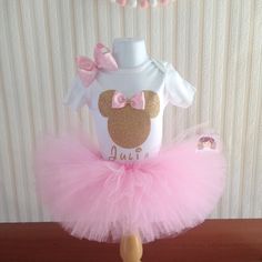 This listing is for a gorgeous tutu set for your precious little one. It Include the onesie, tutu skirt and the bow. All outfits are handmade with lots of tulle and ribbon. I used 1/2" inches non-roll elastic waist bands to prevent twisting and top off with a bow. Type your girl name for the onesie in the * notes to seller box*. I use Carter brand onesies, these onesies are very soft for your baby's skin. The onesie and the shirt are made with high quality vinyl. Onesie: 9 months 6-12 months 18 Cute First Birthday Tutu Dress With Tulle Skirt, Minnie Mouse Tutu, First Birthday Outfits, Pink Birthday, Baby Skin, Tutu Skirt, Lets Celebrate, Birthday Outfit, Baby Pink