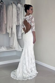 a woman in a white wedding dress standing next to a closet