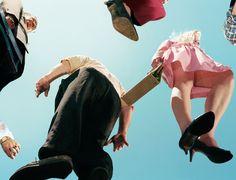 a group of people jumping in the air with hats on their heads and shoes off to the side