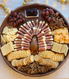 a turkey shaped platter with crackers, cheeses, and other snacks on it