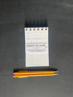 two pencils sitting next to a piece of paper with the words paper to post written on it