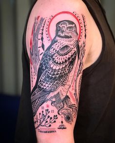 a person with a tattoo on their arm and an owl in the middle of his arm