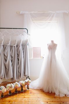 the bride's dress and bouquets are on display in front of her wedding gown