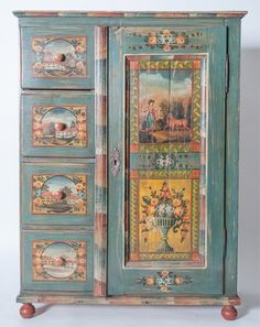 an ornate painted armoire with pictures on the front and sides, in various colors