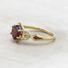 a close up of a ring with a stone in the middle and diamonds around it