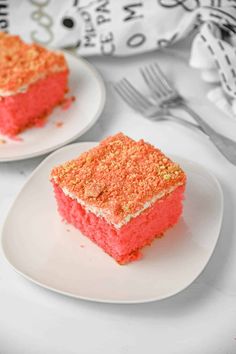 two white plates topped with pink and orange cake