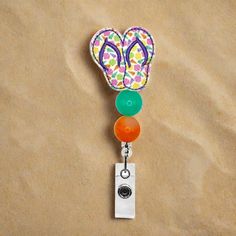 This Sea Shell Flip Flop Badge Reel is the perfect way to make a big splash at the office! Showing off your beach-loving personality with style, its beaded design and retractable, swiveling capabilities keep your ID or access badge just where you need it! Let your coworkers know you don't mess around when it comes to 'work-cessories'! Fun Multicolor Adjustable Badge Holders, Adjustable Multicolor Retractable Badge Reel, Adjustable Retractable Multicolor Badge Reel, Multicolor Retractable Badge Reel, Trendy Accessories, Id Badge, Badge Holders, Badge Reel, Green And Orange