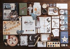 a table topped with lots of assorted items on top of a wooden floor covered in magnets