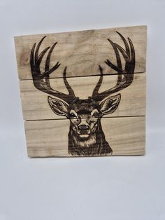 a wooden box with an image of a deer's head on it