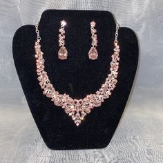 This Necklace Set Features A Silver Tone With Pink Sparkling Jewels. Comes With Necklace And Matching Earrings. Teardrop Jewelry With Sparkling Stones For Evening, Elegant Pink Crystal Jewelry Sets, Teardrop Metal Jewelry For Evening, Sparkling Metal Jewelry For Formal Occasions, Sparkling Teardrop Jewelry For Evening, Elegant Pink Jewelry Sets For Formal Occasions, Evening Rose Gold Jewelry With Sparkling Stones, Evening Teardrop Metal Jewelry, Sparkling Rose Gold Jewelry For Evening