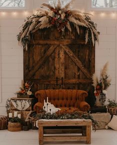 a couch and table in front of a barn door with lights on it's side