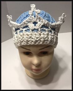 a crocheted blue and white hat on top of a mannequin head