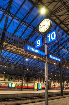 a train station with a clock on the platform