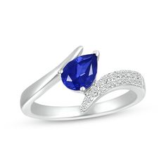 This one-of-a-kind ring displays a luxe pear-shaped blue lab-created sapphire set at a tilt amidst bypassing waves of sterling silver. Round white lab-created sapphires sparkle on one side of the band, which is completed by a rhodium finish. Blue Pear-shaped Jewelry With Polished Finish, Blue Pear Shaped Fine Jewelry Rings, Blue Pear-shaped Fine Jewelry Rings, Blue Pear-shaped Birthstone Ring, Blue Teardrop Birthstone Rings, Blue Teardrop Fine Jewelry Ring, White Lab, Bypass Ring, Ring Displays