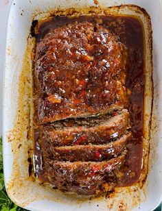 meatloaf in a casserole dish with sauce on top