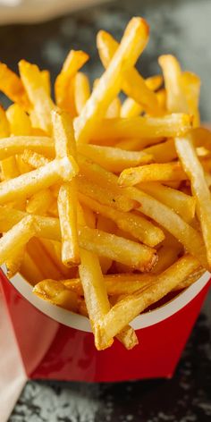 french fries in a red container on a table