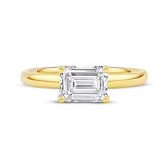 an emerald - cut diamond ring with yellow gold band