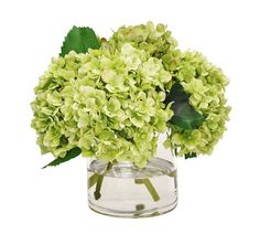 a vase filled with green flowers on top of a table