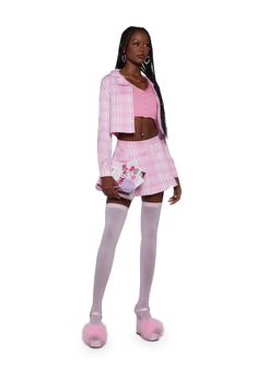 a woman in pink and white is standing with her hands on her hips while wearing thigh high socks