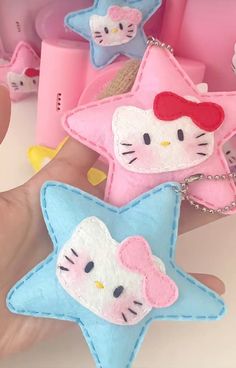 a hand is holding two hello kitty stars