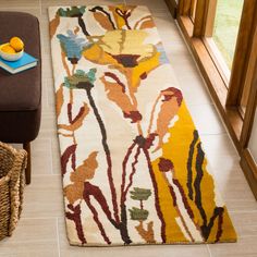 a living room area with a rug, chair and window sill on the floor