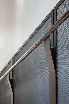 an image of a metal railing in the middle of a building with white walls and grey flooring