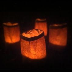 several lit up paper bags in the dark