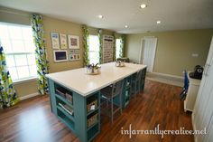 a large kitchen with an island in the middle and lots of counter space on each side