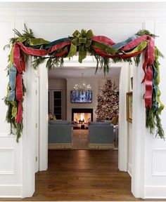 a living room decorated for christmas with decorations