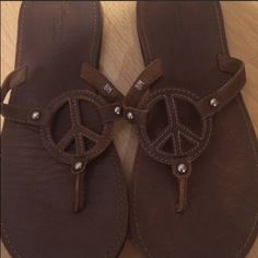 American Eagle Peace Sign Sandals Casual Brown Flat Sandals, Comfortable Brown Round Toe Flip Flops, Comfortable Brown Slip-on Flip Flops, Comfortable Brown Closed Toe Flip Flops, Comfortable Brown Flip Flops, Casual Brown Open Toe Flip Flops, Brown Flat Flip Flops, Casual Brown Flip Flops With Leather Footbed, Brown Flip Flops With Removable Insole For Spring