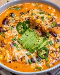 a spoonful of mexican soup with beans, corn and avocado