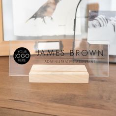 an acrylic business card holder with a bird on it and the name james brown