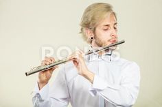 a man in white shirt and bow tie playing the flute