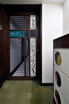 an entryway with decorative glass and wooden doors