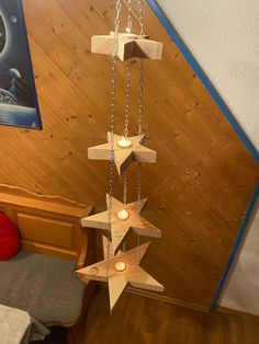 a wooden star mobile hanging from a ceiling