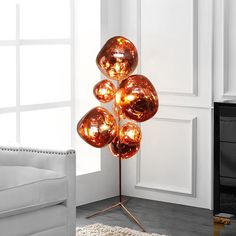 a modern floor lamp in the corner of a living room