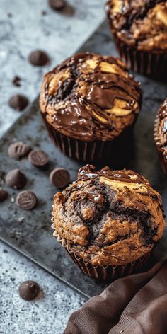 chocolate chip muffins on a baking tray with chocolate chips