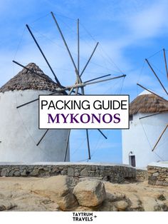 two white windmills with the words packing guide mykonos in front of them