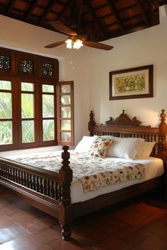 a bed sitting in the middle of a bedroom next to two windows with wooden shutters