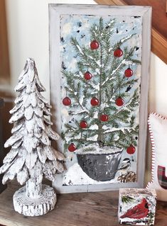 a white christmas tree sitting on top of a wooden table