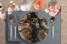 a place setting with plates, silverware and flowers