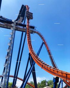 an orange and blue roller coaster going down a hill