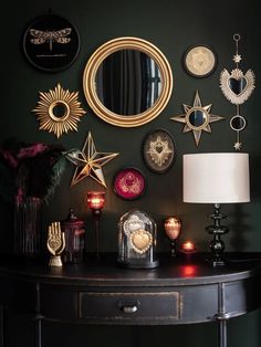 a black table topped with lots of different types of decorations on it's wall