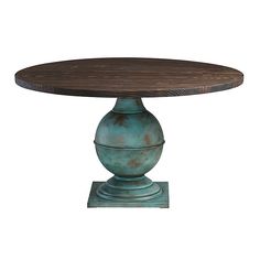 a round wooden table sitting on top of a metal base with a blue vase underneath it