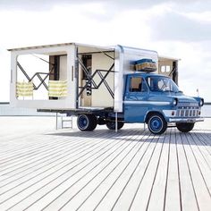 an old truck is parked on the boardwalk